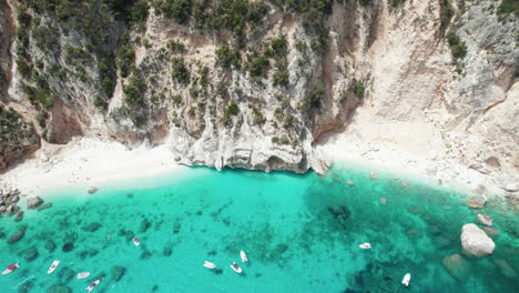 Aerial-drone-video-of-tropical-paradise-beach-in-summer-in-the-mediterranean,-Cala-Luna,-Sardinia,-Italy