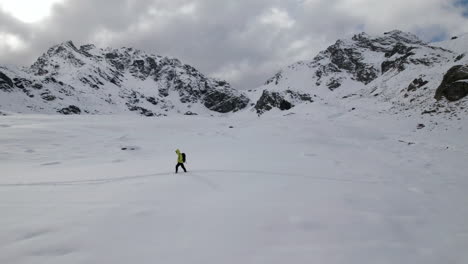 Luftaufnahme-Eines-Alpinisten,-Der-An-Einem-Bewölkten-Tag-In-Den-Europäischen-Alpen-In-Schneebedeckten-Bergen-Vorrückt