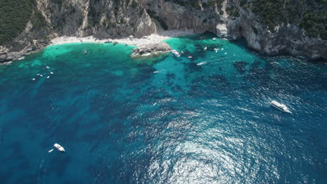 Aerial-drone-video-of-tropical-paradise-coast-in-the-mediterranean,-Sardinia,-Costa-Azzurra,-with-boats