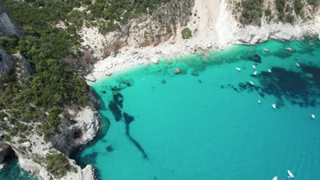 Aerial-drone-video-of-tropical-paradise-turquoise-water-and-sea-cliffs-in-the-mediterranean,-Cala-Goloritz?