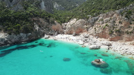 Aerial-drone-video-of-tropical-paradise-beach-in-summer-in-the-mediterranean,-Cala-Goloritzè,-Sardinia,-Italy