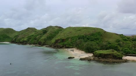 aerial-panoramic-of-green-hills-at-Bukit-Merese-Beach-in-Lombok-Indonesia-on-cloudy-day