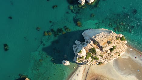 top-down-zoom-out-Aphrodite-rock-cyprus-emerald-green-and-blue-ocean