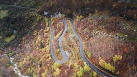 A-single-car-following-a-serpentine-road-above-the-Geiranger-fjord