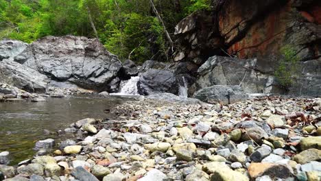 Small-WaterFall,-Cascading-Into-A-Creek,-Surrounded-By-Rocks-In-Costa-Rica
