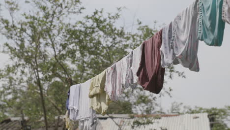 Slow-motion-rack-focus-of-a-line-of-clothes-drying-out-in-the-sun