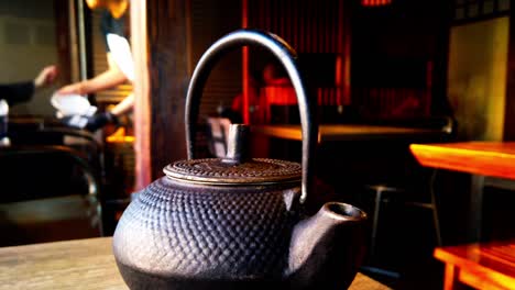 Ancient-Pattern-Black-Cast-Iron-Teapot-Japanese-Tetsubin-Tea-Set-for-Wood-Stove-with-Stainless-Steel-Infuser-for-Leaf-Loose-Tea-Blooming-Flower-Tea-600ml-20oz-hand-made-rotating-Bokeh-Background