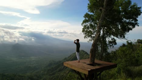 man-at-Lahangan-Sweet-Viewpoint-tourist-attraction-on-sunny-day-in-Bali,-aerial