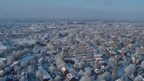 Wide-aerial-establishing-shot-of-Nottingham-england-covered-in-a-blanket-of-snow,-housing-market-freeze-concept-shot