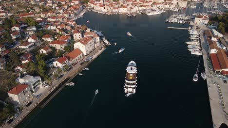 Drone-follow-shot-of-cruise-ship-coming-back-to-port-of-Mila,-Brac-Island,-Croatia