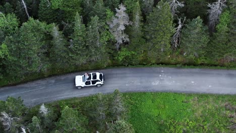 aerial-drone-headshot-of-jeep-in-stowe-forest-road,-Vermont