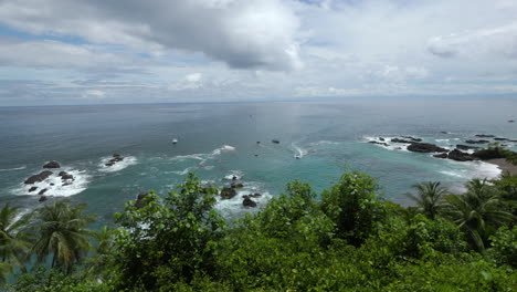 Infinite-sea-viewed-from-a-viewpoint-on-top-of-the-trees-over-a-paradisiac-beach,-in-Corcovado,-Costa-Rica