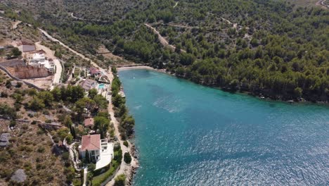 Aerial-orbit-shot-revealing-secluded-beach-with-luxury-homes-on-Brac-island,-Croatia,-Adriatic-Sea