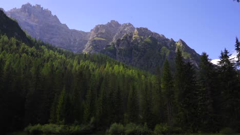 Wide-shot-o-a-mountain-landscape-in-the-Italian-Dolomites-with-a-pine-forest-in-the-foreground