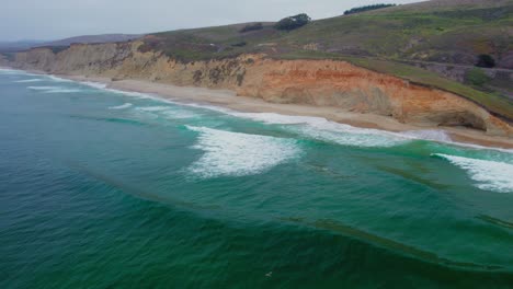 Aerial-view-drone-shot-slow-rise-by-California-coast-rock-cliffs-on-a-foggy-day-on-Pacific-Coast-Highway