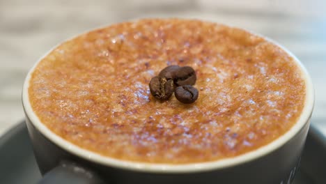 A-cup-of-Brulee-coffee-with-a-crystalized-hard-brittle-layer-of-caramel-and-coffee-beans