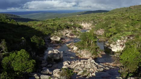 Aerial-drone-dolly-in-flying-shot-above-an-incredibly-stunning-rocky-and-windy-river-leading-to-the-Devil's-Pit-on-a-hike-in-the-beautiful-Chapada-Diamantina-National-Park-in-Northeastern-Brazil