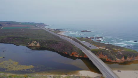 Aerial-Drone-View-Of-Car-Driving-in-Fog-On-Pacific-Coast-Highway-by-San-Gregorio-Beach-in-California,-USA