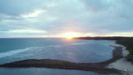 Cloudy-sunrise-over-Turtle-bay-in-Oahu,-Hawaii,-panoramic-aerial-view