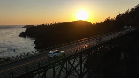 Drone-shot-passing-over-Canoe-Pass-at-Deception-Pass-Bridge-with-cars-commuting-underneat
