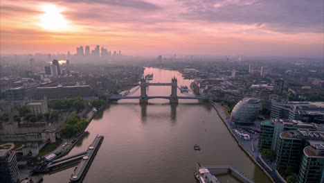 Dramatic-fast-dolly-zoom-out-aerial-drone-view-of-Tower-Bridge-on-evening-pink-sky,-London,-UK,-hyperlapse