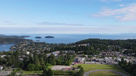 Aerial-view-of-a-football-field-and-buildings-at-the-picturesque-sunshine-coast-in-Gibsons,-British-Columbia