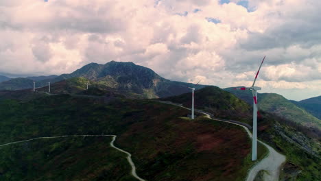 Wind-turbines-generate-clean,-sustainable-energy-on-a-mountaintop-in-Europe---aerial-view