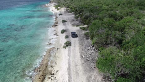 car-driving-near-ocean-on-a-island-drone-view