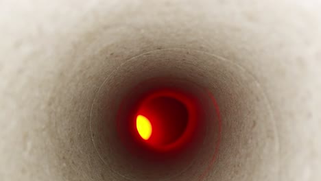 Detailed-macro-of-fibers-in-the-tube,-moving-deep-inside-a-paper-towel-tube-with-an-offset-red-light-at-the-end