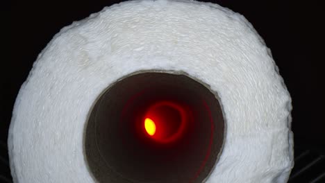 Starting-outside-a-paper-towel-roll,-moving-deep-inside-the-tube-towards-an-offset-red-light-at-the-end