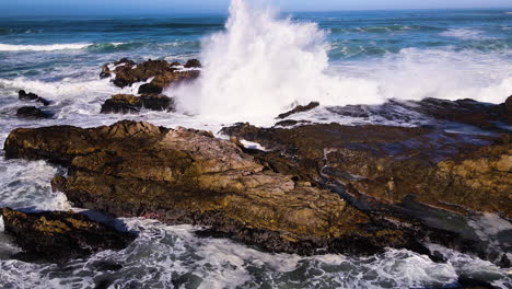 Waves-crash-violently-against-rugged-coastline---frothing-seawater