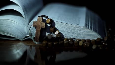 bible-with-cross-on-table-with-black-background-no-people-stock-footage