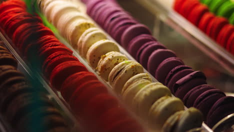Assorted-brightly-colored-French-macarons-in-display-case,-right-pan-into-focus