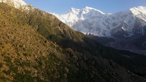 Drone-shot-of-over-mountain-cliffs-towards-Nanga-Parbat,-Fairy-Meadows-Pakistan,-snow-capped-mountains,-cinematic-aerial-shot