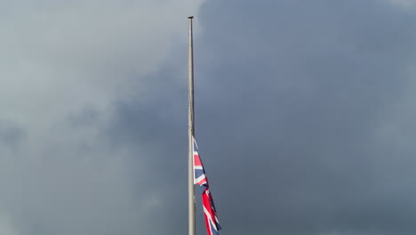 Union-Jack-Flag-In-Cornwall-Half-masted-Against-Dramatic-Sky-Following-The-Death-Of-Her-Majesty,-Queen-Elizabeth-II