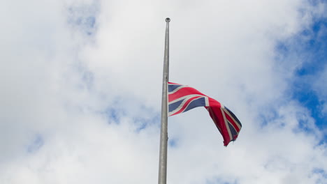 Slow-Motion-Waving-In-Half-mast-Of-Union-Jack-Flag-In-Cornwall-As-UK-Nation-Mourns-Death-Of-Queen-Elizabeth-II