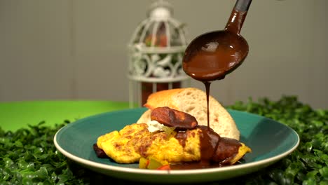Dressing-mexican-omelette-with-mole-curry-species-in-slow-motion-mexico-recipe