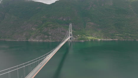 Aerial-shot-of-traffic-flow-on-Hardanger-Bridge-over-fjord,-Norway