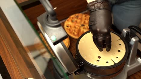 Adding-preparing-topping-chocolate-chips-in-to-waffle-maker-oster-gofrera-slow-motion