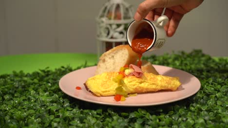dressing-adding-hot-sauce-to-a-mexican-omelette-in-slow-motion-chile-picante
