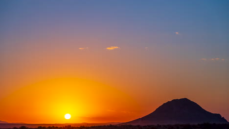 A-fiery-sunrise-in-the-Mojave-Desert-landscape-with-a-butte-in-silhouette---time-lapse