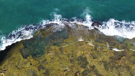 Aerial-view-of-waves-breaking-on-the-rocks