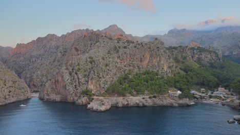 Slow-drone-panning-shot-of-Sierra-de-Tramuntana-with-Sa-Calobra-and-Torrent-de-Pareis-in-front-of-the-Mediterranean-sea-at-Mallorca,-Spain