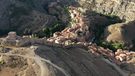 Aerial-view-of-Albarracin-village,-one-of-the-most-beautiful-places-in-Spain-,-recorded-just-after-dawn-in-a-late-summer-morning