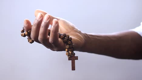 man-praying-to-god-with-cross-in-hands-together-with-cross-stock-footage