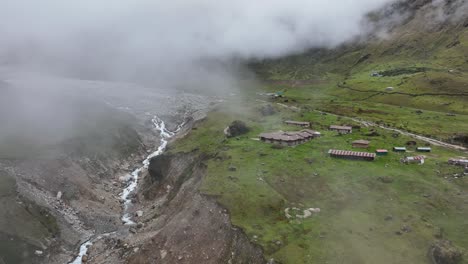 Aerial-drone-fly-view-at-the-top-of-Salkantay-trek-from-Cusco-to-Machu-Picchu-in-the-Peruvian-Andes-during-a-sunny-and-foggy-morning,-Peru,-South-America,-The-way-on-Salkantay-trek,-Peru