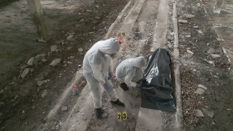 Two-forensic-specialists-are-working-at-the-crime-scene