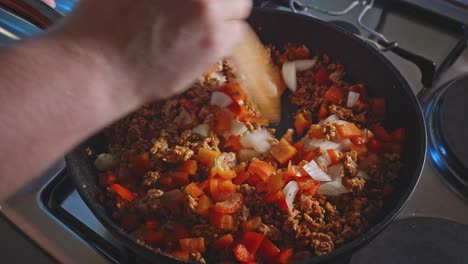 Stirring-Chopped-Red-Bell-Pepper,-White-Onion,-And-Ground-Turkey-In-A-Cooking-Pan