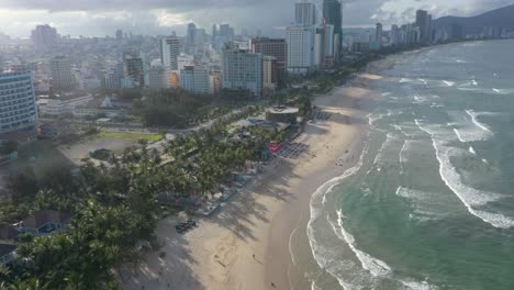 Aerial-view-of-long-white-sand-stretch-My-Khe,-My-Bac-An-and-Non-Nuoc-beach-with-huge-waves-in-Danang,-Central-Vietnam