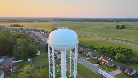 Pan-Aerial-shot-of-the-watertower-in-Clarksville-revealing-a-beautiful-sunrise-at-the-end